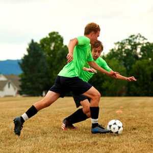 male soccer players going against each other
